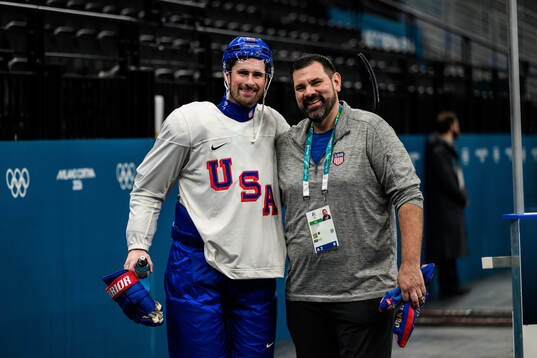 Dylan Larkin with equipment manager Teddy Richards of USA