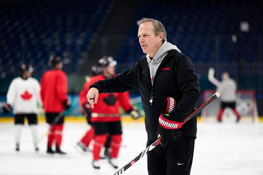 Head coach Jon Cooper of Canada at an ice hockey practice