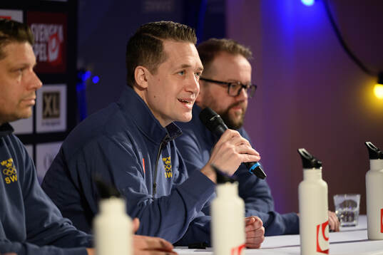 Head coach Sam Hallam at a press conference with the