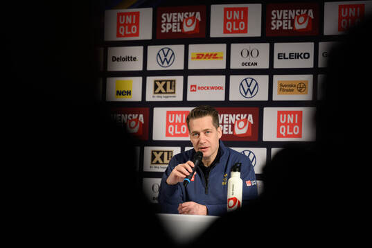 Head coach Sam Hallam at a press conference with the