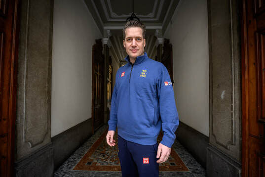 Head coach Sam Hallam poses for a portrait at a press