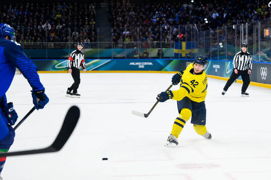 Gustav Forsling of Sweden scores 2-1 in the men's ice