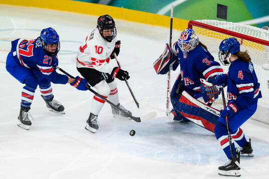 Taylor Heise, goaltender Aerin Frankel and Caroline Harvey