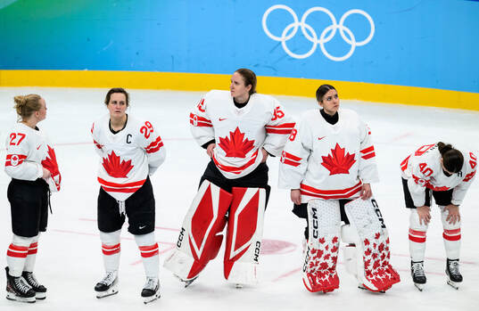 Marie-Philip Poulin and goaltender Ann-Renee Desbiens of