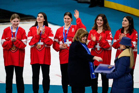 Alina Muller of Switzerland celebrates as she is handed her