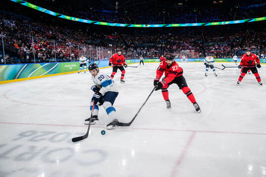 Sebastian Aho of Finland and Shea Theodore of Canada in the