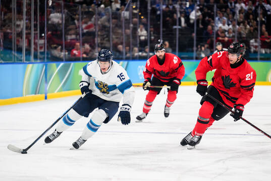 Anton Lundell of Finland and Thomas Harley of Canada in the
