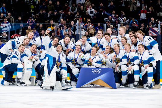 Players of Finland celebrate with their bronze medals