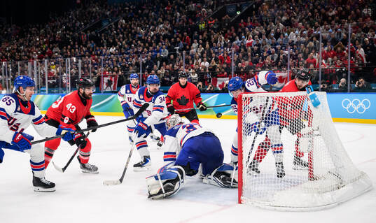 Tom Wilson of Canada against goaltender Connor Hellebuyck