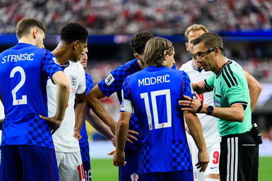 Luka Modric of Croatia and Referee Clement Turpin