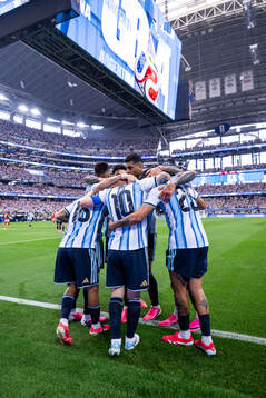Lionel Messi of Argentina celebrates with Cristian Romero,