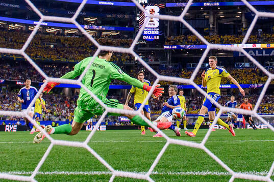 Daizen Maeda of Japan scores 1-0 behind goalkeeper Jacob