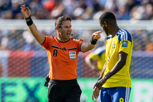 Referee Danny Makkelie and Alexander Isak of Sweden