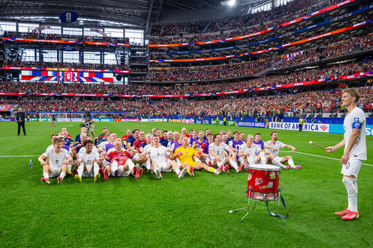 Players and staff of Norway celebrate with a viking row