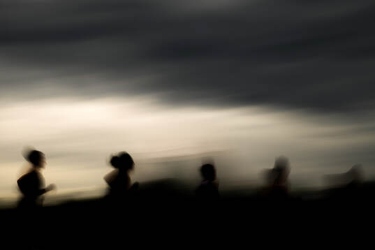 The silhouettes of Narve Gilje Nordås and athletes