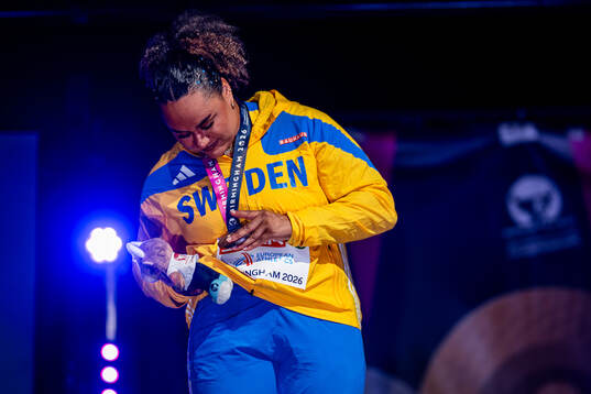 Vanessa Kamga of Sweden wipes lipstick off her medal at the